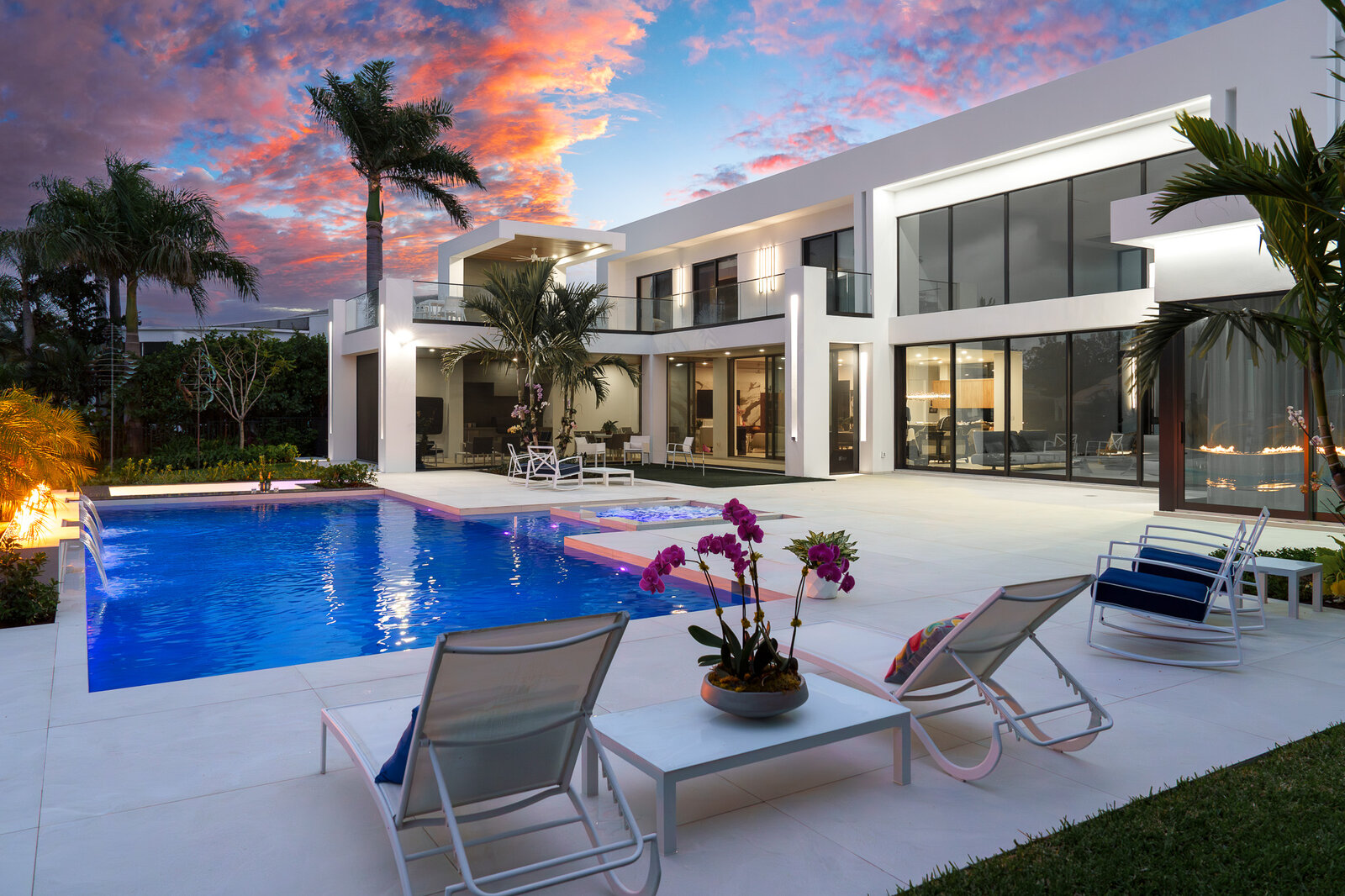 Luxury home with pool, orchid, and cotton-candy twilight sky